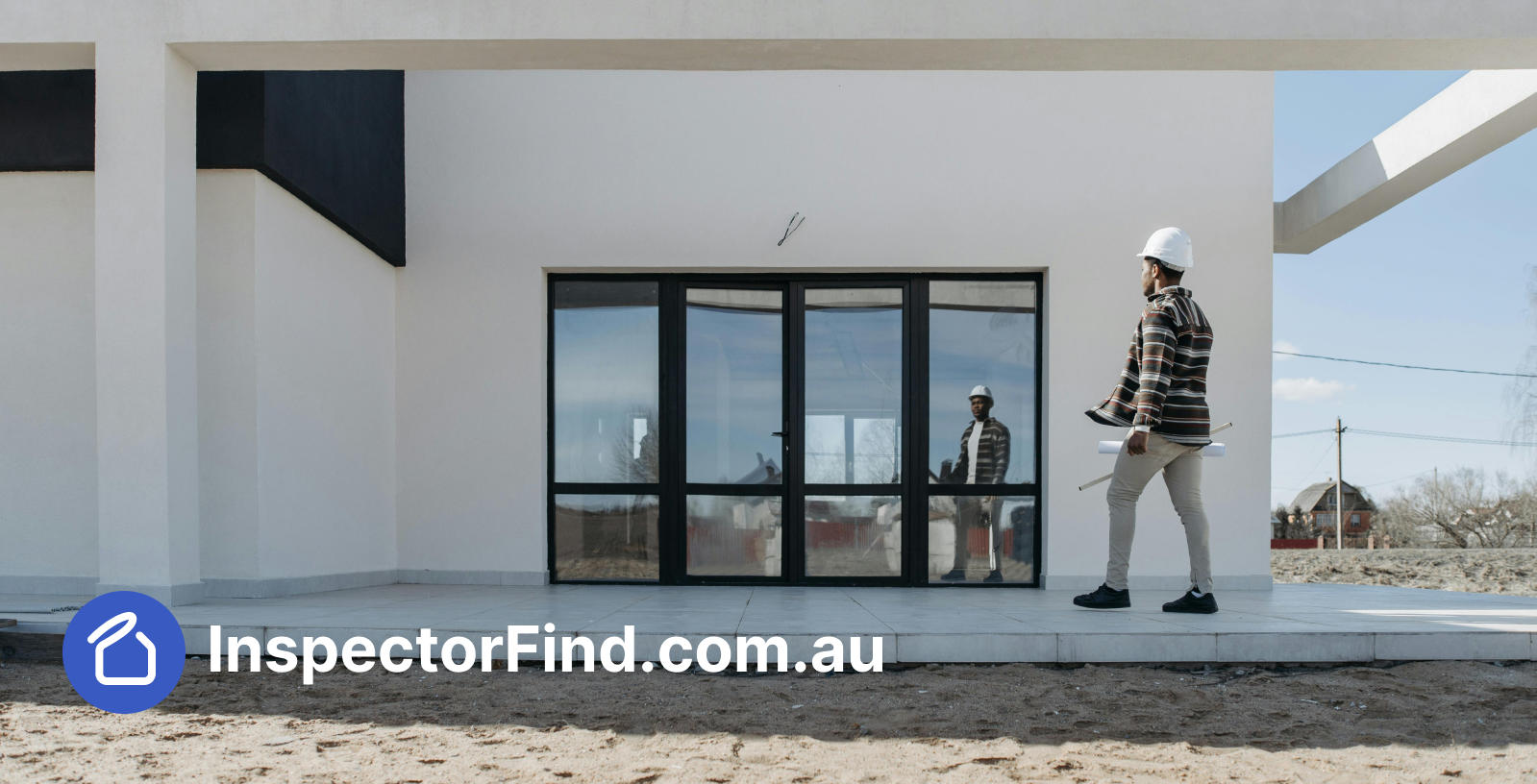 Building inspector with blueprints at a modern property — InspectorFind.com.au branding